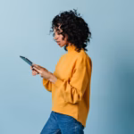 welldressed-girl-using-digital-tablet-studio-shot-pretty-young-lady-yellow-sweatshirt_197531-26844